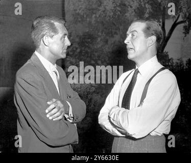 Cary Grant visits Ray Milland , both English born, on the set of Hitchcock's film ' Dial M for Murder' in which Millan stars. Stock Photo