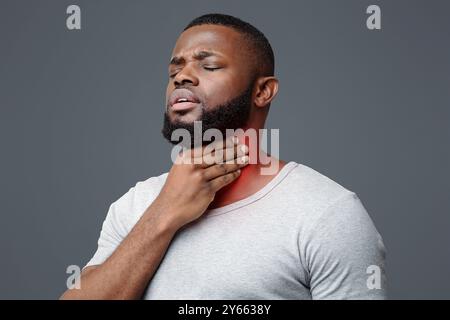 Sad afro man suffering from sore throat Stock Photo