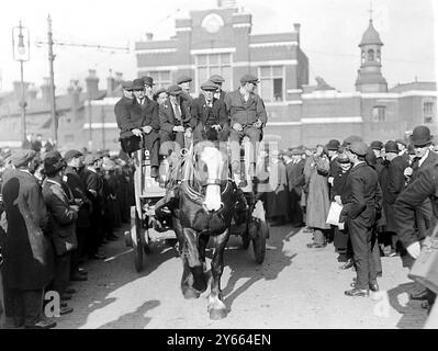 March of Ex Soldiers from Woolwich Arsenal to see the premier. Wounded men leaving the Arsenal in a cart.  6th March 1920 Stock Photo