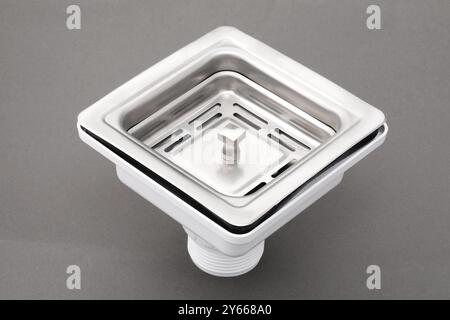 Closeup of sink waste coupling square chrome stainless steel silver floor drain isolated on white background. Stock Photo