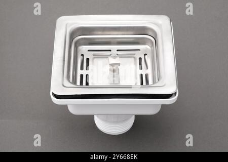 Closeup of sink waste coupling square chrome stainless steel silver floor drain isolated on white background. Stock Photo