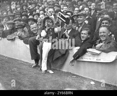 A young Arsenal supporter exercising his lungs on behalf of his tewam at the London 'Derby' between Arsenal and Tottenham Hotspurs at Highbury 20 October 1934 Stock Photo