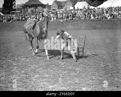 Haywards Heath Horticultural Society's Summer show, Victoria Park, Haywards Heath, Sussex. Girl with pony in Musical Chairs competition.   9 July 1936 Stock Photo