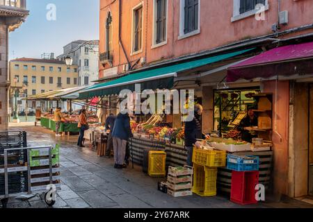 People shopping for fish and fruit and vegetables at Rialto Market in the San Polo sestiere of Venice ,Italy Stock Photo