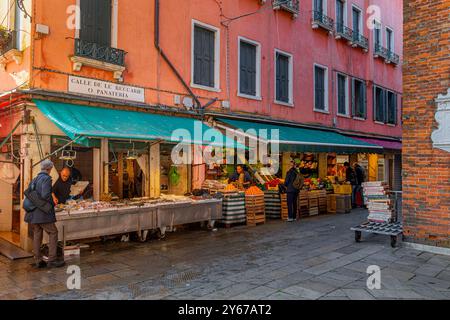 People shopping for fish and fruit and vegetables at Rialto Market in the San Polo sestiere of Venice ,Italy Stock Photo