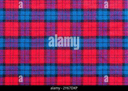 The texture of linen fabric in a large cage of blue, red. Scottish tailoring material. Checkered fabric Stock Photo
