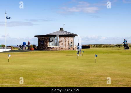 Golfers on a Sunny Day at the putting and chipping practice areas  adjacent to the 1st tee, North Berwick Golf Club West Links, Scotland, UK Stock Photo