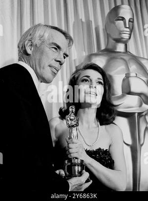 Santa Monica, California. Actress Anne Bancroft accepts the award for Best Actress on the behalf of Elizabeth Taylor for her part in 'Who's Afraid of Virginia Woolf' from last year's Best Actor Lee Marvin. 13th April 1967 Stock Photo