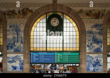Old and new, with electronic signage and blue and white tiles panels (azulejos), interior Estacao Sao Bento, Porto's famous railway station, Portugal Stock Photo