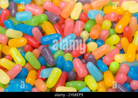 Many brightly colored jelly beans in a rainbow of pastel colors. Popular candy for Easter. Stock Photo