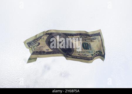 dollar bill. on wet glass Stock Photo