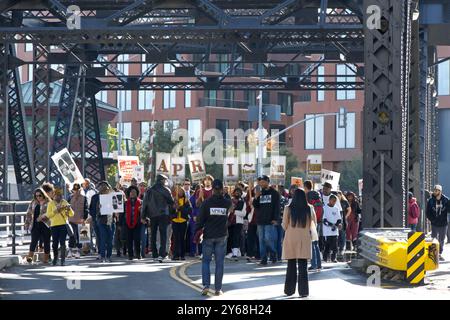 San Francisco, CA - Jan 15, 2024: Participants in Martin Luther King March walking from Caltrain station down 4th St over the bridge then up 3rd St ov Stock Photo