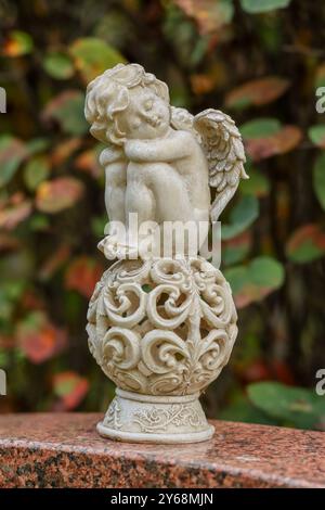 There are many beautiful little angel statues in the graves of the old Hietaniemi cemetery in Helsinki. Stock Photo