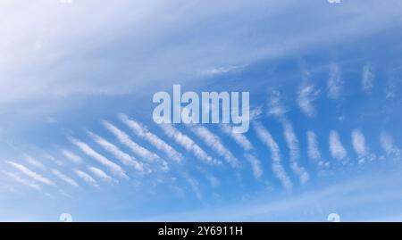 Stripes at blue sky formed by high-altitude cirrocumulus clouds , Finland Stock Photo