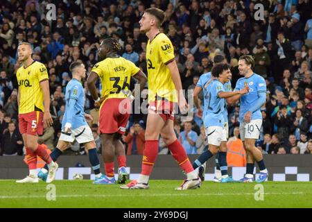 Manchester, UK. 24th Sep, 2024. Manchester City players celebrate their second goal of the game whilst Watford players react with dejection after 2-0 during the Manchester City FC v Watford FC Carabao Cup 3rd Round match at the Etihad Stadium, Manchester, England, United Kingdom on 24 September 2024 Credit: Every Second Media/Alamy Live News Stock Photo