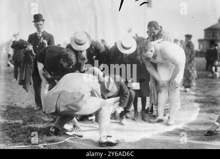 Pat McDonald examines tape, Photo shows Patrick Joseph McDonald (McDonnell) (1887-1954), a member of the American track and field team at the 1912 Summer Olympics in Stockholm., 1912, Track athletics, Glass negatives, 1 negative: glass; 5 x 7 in. or smaller. Stock Photo