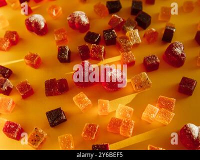 Yummy candied fruit jelly on yellow background Stock Photo