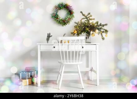 Interior of light room with workplace decorated for Christmas Stock Photo
