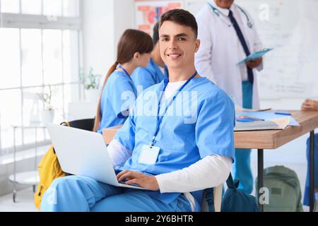 Male medical student with laptop sitting at lecture Stock Photo