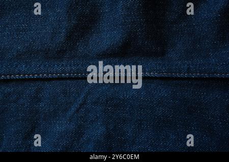 Raw blue denim jeans texture background with seam line in the middle Stock Photo