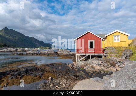 Traditional fishermen's houses, called rorbuer, on rocky coast of Vestfjord, Sorvagen, Lofoten, Norway, Europe Stock Photo