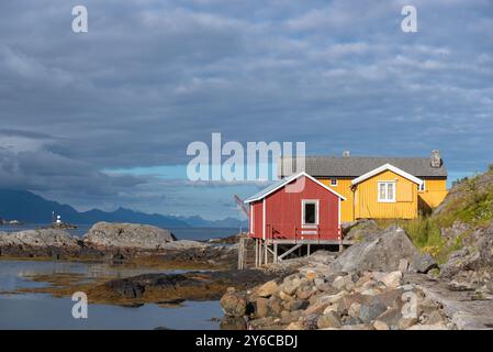 Traditional fishermen's houses, called rorbuer, on rocky coast of Vestfjord, Sorvagen, Lofoten, Norway, Europe Stock Photo