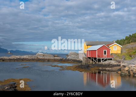 Traditional fishermen's houses, called rorbuer, on rocky coast of Vestfjord, Sorvagen, Lofoten, Norway, Europe Stock Photo