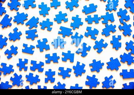 Different many blue puzzle pieces on white table background Stock Photo
