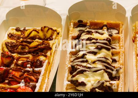 Belgian waffles with colorful sweet toppings and fruits for sale in Brussels, Belgium Stock Photo