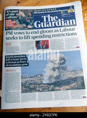 Keir Starmer 'PM vows to end gloom as Labour seeks to life spending restrictions' Guardian newspaper headline front page Conference article London UK Stock Photo