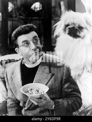 ACTOR PETER SELLERS WITH A DOG ON A SET HEAVENS ABOVE IN LONDON  /  ;  22 MAY 1963 Stock Photo