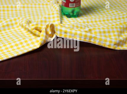 crumpled checkered tablecloth with water bottle in the background Stock Photo