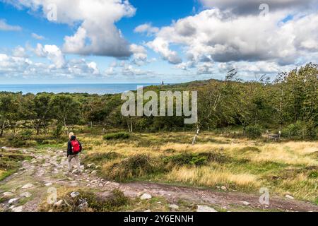 Coastal hike from Mölle harbor to Kullen lighthouse in the Naturum Kullaberg nature reserve. At the tip of the Kullaberg peninsula stands the Kullens fyr lighthouse. Italienska vägen, Höganäs kommun, Skåne, Skåne, Sweden Stock Photo