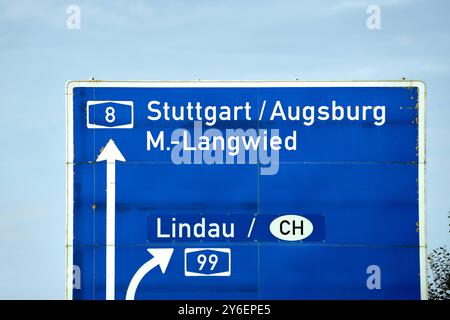 Bavaria, Germany - September 23, 2024: A highway sign indicates the directions Stuttgart, Augsburg and Munich-Langwied A8 as well as Lindau and Switzerland CH. It marks an important traffic junction on a German highway *** Ein Autobahnschild weist auf die Fahrtrichtungen Stuttgart, Augsburg und München-Langwied A8 sowie Lindau und die Schweiz CH hin. Es markiert eine wichtige Verkehrskreuzung auf einer deutschen Autobahn Stock Photo