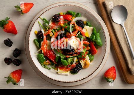 Healthy red berry and brie salad. Top view table with decorations. Stock Photo