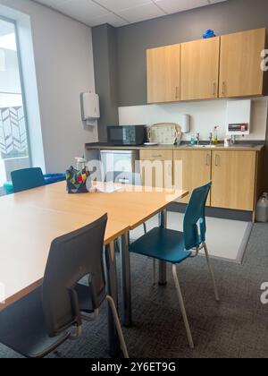 Conference meeting room table staffroom in school with kitchen Stock Photo
