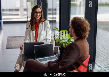 Business Meeting in a Modern Office Environment Featuring Laptops and Technology Tools Stock Photo