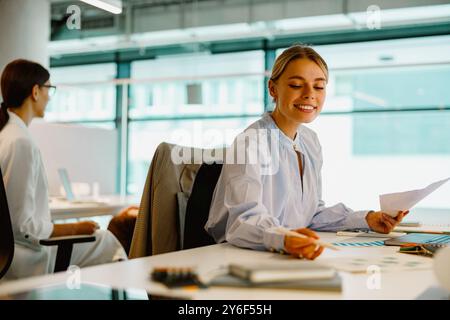 Young Professionals Excitedly Collaborating in a Modern Office Working Environment Stock Photo
