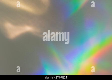 Defocused rainbow light reflection on white building. Sunlight flare refraction on white wall. Abstract natural light holographic background Stock Photo