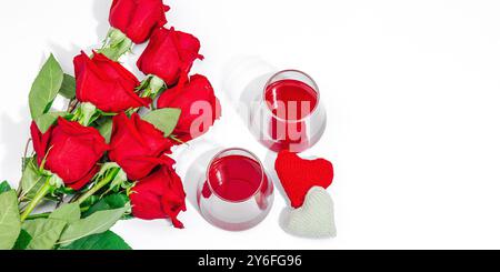 The concept of a romantic date. Two glasses of wine, handmade hearts, a bouquet of red roses. Trendy hard light, dark shadow, white background, flat l Stock Photo