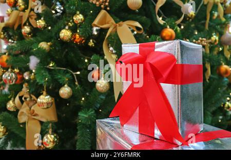 Christmas Decorations with Christmas Tree Filled with Ornament and Stack of Gift Boxes Stock Photo