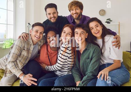 Portrait of smiling happy group of multiracial best friends hanging out together at home party. Stock Photo