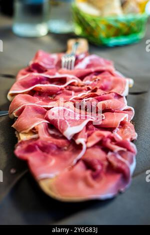 Ham slices Board, a classical cold cuts appetizer. Stock Photo