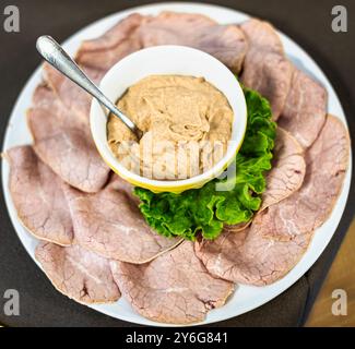 The traditional Piedmont appetizer, the Vitello tonnato. Veal slices servet with a tuna, egss and capers sauce. Stock Photo