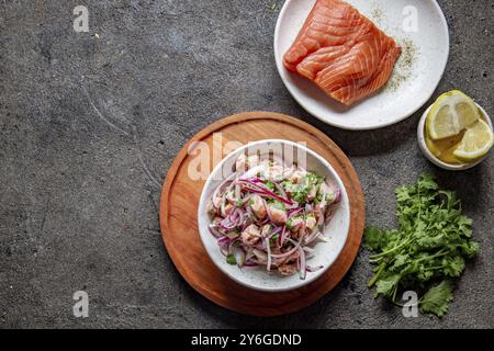 Food, Food, CHILEAN SALMON CEVICHE. Fresh raw salmon marinaded with purple onion, coriander in lemon juice. Sebiche and ingredientes on gray backgroun Stock Photo