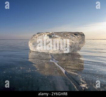Frozen Lake Baikal landscape, sunlight is refracted in piece of ice Stock Photo