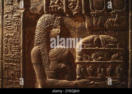 Hieroglyphic drawings and paintings on the wall of the corridor of the ancient Egyptian temple of Dendera Stock Photo