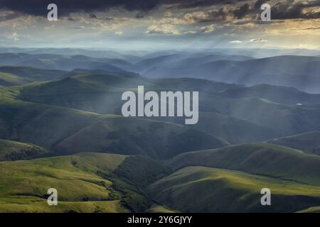 Beautiful landscape of the sunbeams on hills in Caucasus mountains at sunset, Russia, Europe Stock Photo