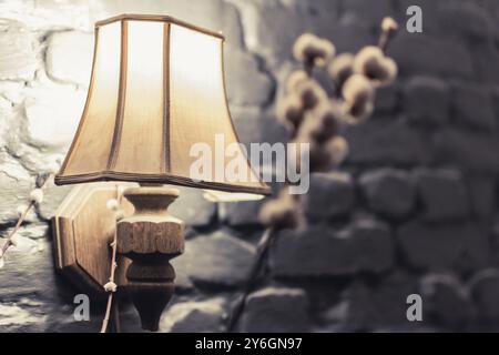 Retro wooden lampshade against black brick wall. Cozy living and interior decoration Stock Photo