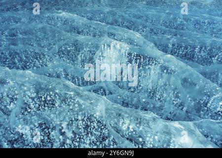 Beautiful transparent blue ice and frozen methane bubbles on Baikal Lake background texture Stock Photo